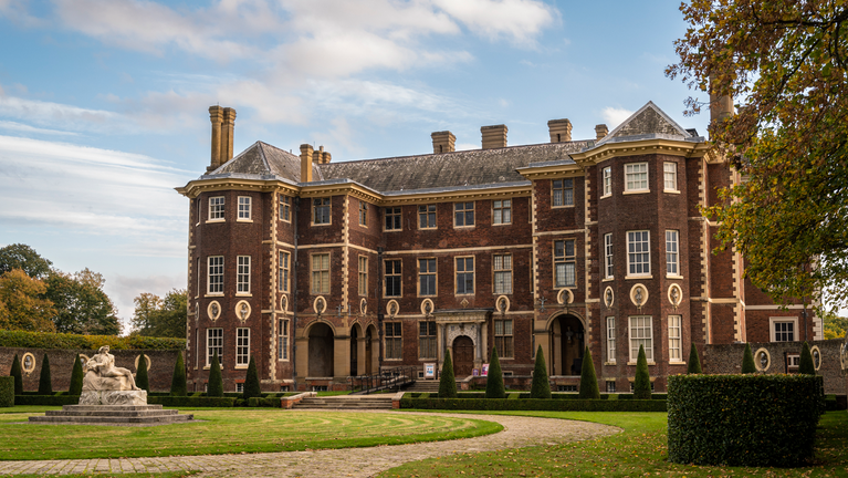 The front side of the house at Ham House against the backdrop of a bright blue sky